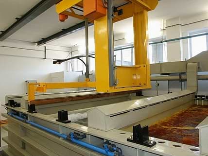 Automated 600Kg carrier on Anodising plant showing tanks with lip extraction